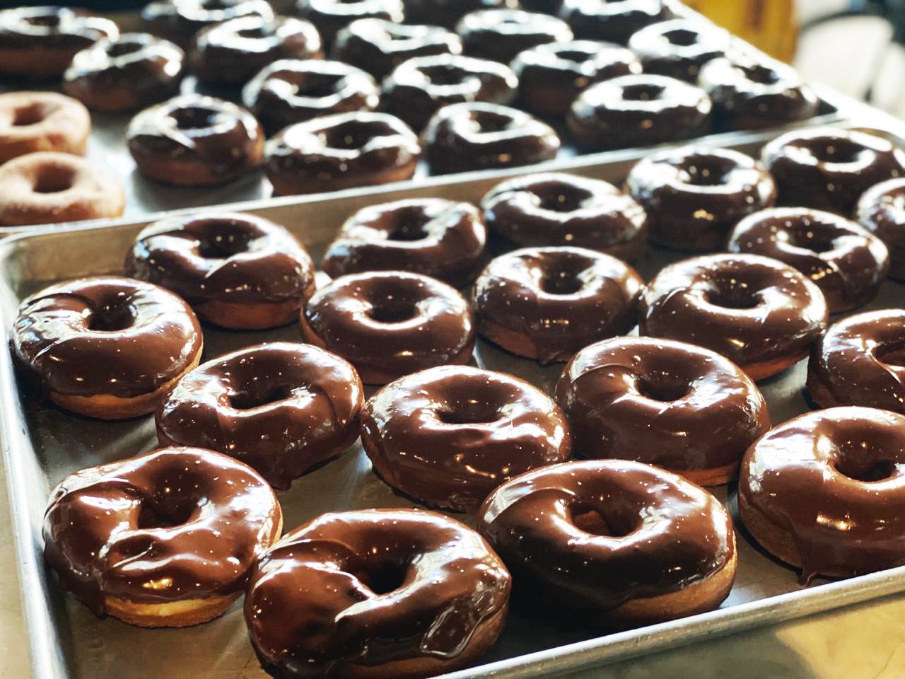 Tray of Chocolate Donuts with Chocolate Frosting dessert or pastry