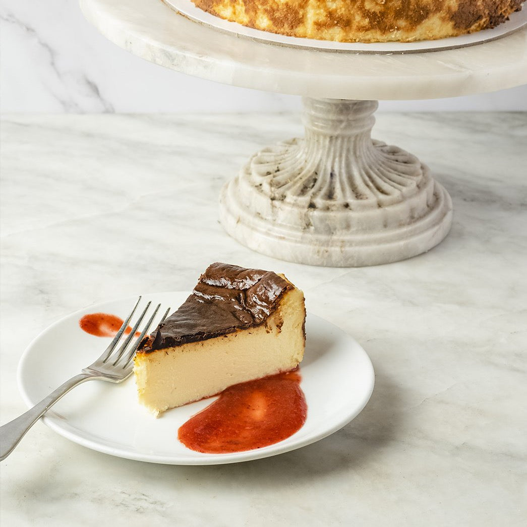 Slice of Classic Mascarpone Cheesecake with Strawberry Jam dessert or pastry