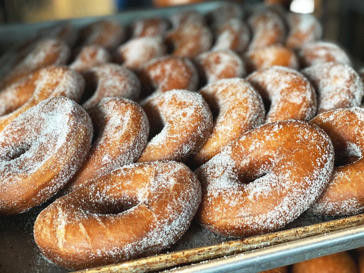 Tray of Old Fashioned Donuts topped with Sugar dessert or pastry